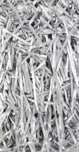 a pile of shredded paper is sitting on a table .