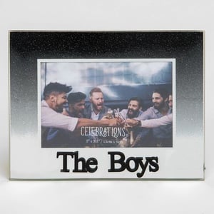 A picture frame with a picture of a group of men toasting with drinks.