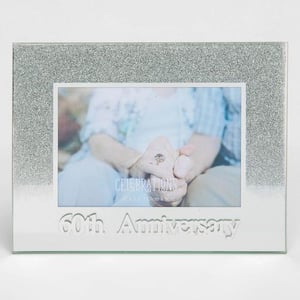 A picture frame for a 60th anniversary with a picture of a man and a woman holding hands.