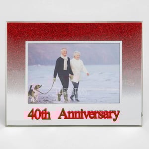 A picture frame for a 40th anniversary with a man and woman walking with a dog.