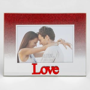 A picture frame with a picture of a man and a woman hugging and the word "love" on it.