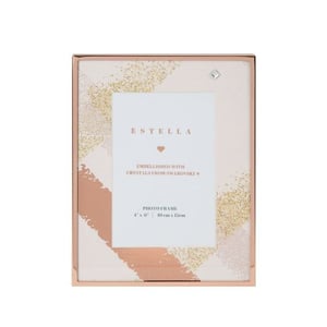 A rose gold photo frame with a heart on it.