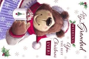 On a Christmas card, a teddy bear is holding a cup of coffee.