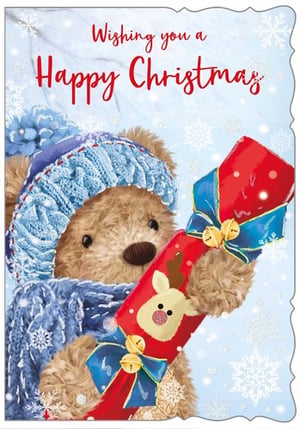 A teddy bear is holding a Christmas cracker with a reindeer on it.