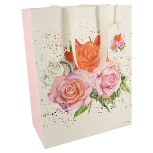 A gift bag with a painting of roses on it.