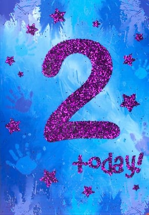 The number 2 is made of pink glitter and stars on a blue background.