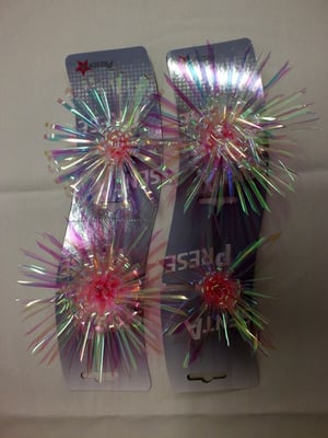 A pair of hair clips that say "Fiesta" on them.