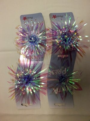 A pair of hair clips that say "fiesta" on them.
