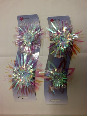 A pair of hair clips that say "sparkle" on them.