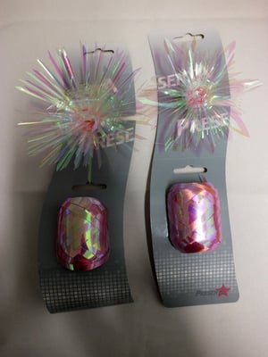 A pair of hair clips that say 'shimmer' on them.