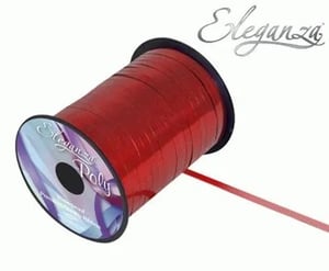 A spool of red ribbon on a white background.
