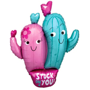 A pink and blue cactus balloon that says "stuck on you."