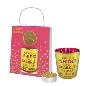 A happy birthday gift bag with a candle in it.