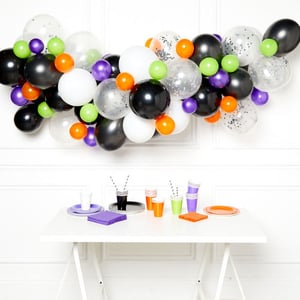 A table with a bunch of balloons on it.