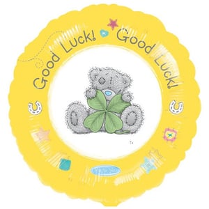 A yellow balloon that says "good luck" on it.