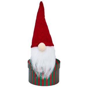 A Christmas gnome in a red and green striped box.