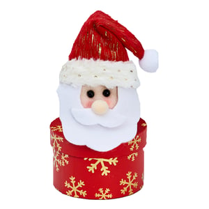 A Santa Claus figurine in a red box with gold snowflakes.