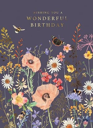 A birthday card with flowers and butterflies is on a purple background.