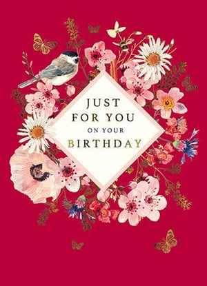 A birthday card with flowers and a bird on a red background.