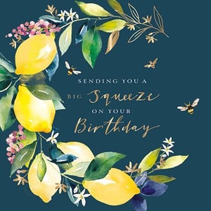 A birthday card with lemons, flowers, and bees is on a dark blue background.