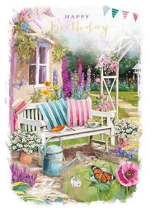 A birthday card with a painting of a bench in a garden surrounded by flowers and butterflies.