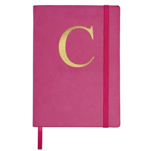 A pink notebook with a gold letter "C" on it.