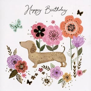 A happy birthday card with a dachshund surrounded by flowers.