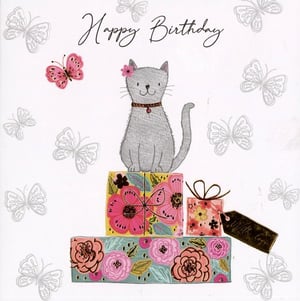 A birthday card with a cat sitting on a stack of presents.