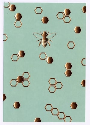 A bee is surrounded by honeycombs against a blue background.