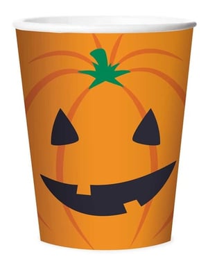 A paper cup with a pumpkin face on it.