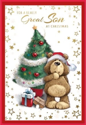 a teddy bear wearing a santa hat stands in front of a christmas tree
