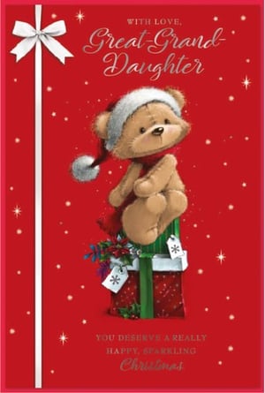 a teddy bear wearing a santa hat is sitting on top of a christmas present .