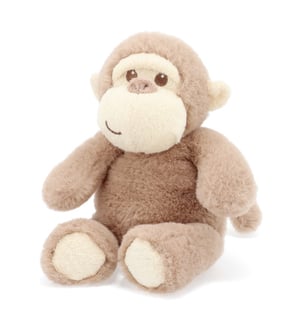 A stuffed monkey is sitting on a white background.