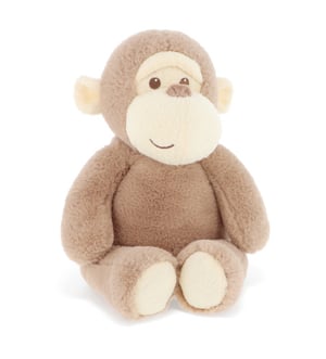 A stuffed monkey is sitting on a white background.