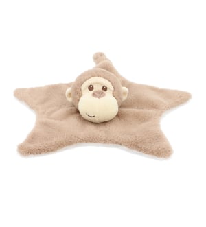 A stuffed monkey is lying on a star-shaped blanket.
