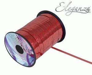 A spool of red ribbon on a white background.