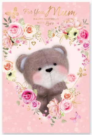 A birthday card with a teddy bear surrounded by flowers.