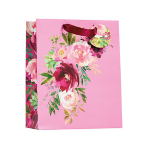 a pink gift bag with a floral design on it