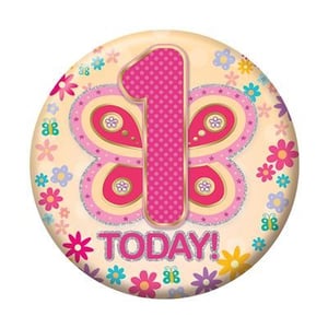 a birthday badge for a girl with a butterfly and flowers on it .
