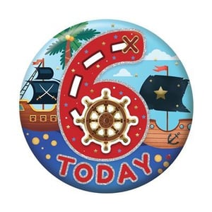 a button with a pirate theme and the number six on it .