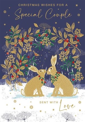 a couple of rabbits sitting next to each other in the snow on a christmas card .