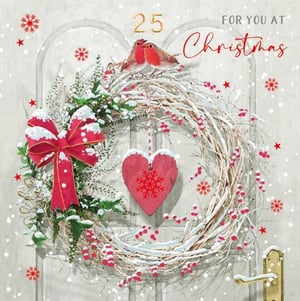 a christmas card with a wreath and a heart on a door .