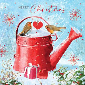 two birds are sitting on top of a red watering can in the snow .