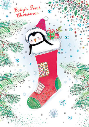 a baby 's first christmas card with a penguin in a stocking