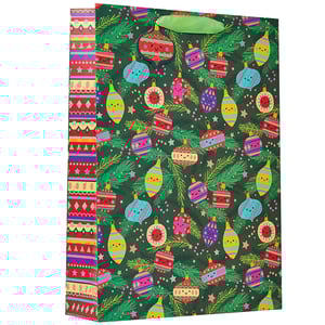 a green gift bag with christmas ornaments on it