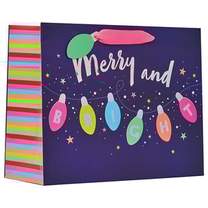 a gift bag that says merry and bright on it