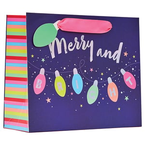 a gift bag that says merry and bright on it
