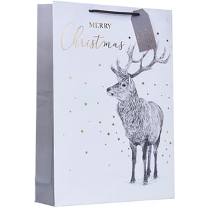 a merry christmas gift bag with a deer on it