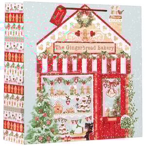 a gingerbread bakery with a sign that says happy christmas