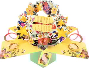 a pop up easter card with a wreath of flowers on it .